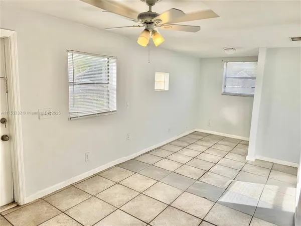 a view of a room with tiles and a ceiling fan
