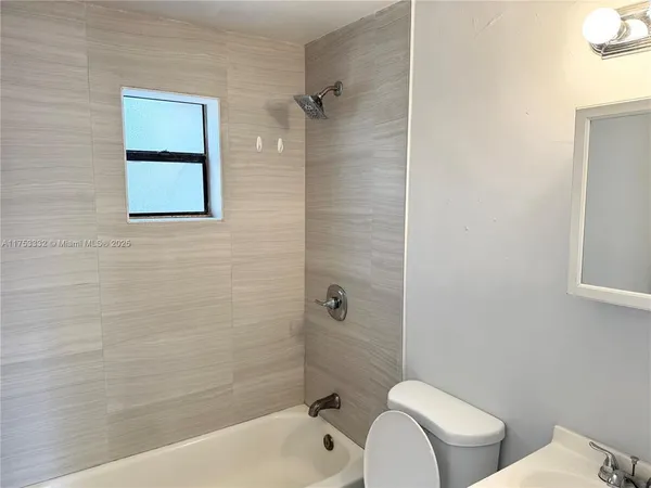 a bathroom with a toilet and a bathtub