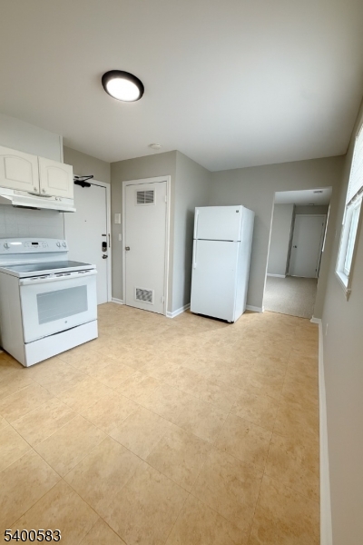 20 Orchard Street, Unit 3 Summit, NJ 07901 - Photo 2 of 6 a view of a kitchen with refrigerator and cabinets