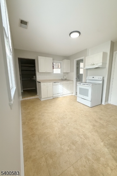 20 Orchard Street, Unit 3 Summit, NJ 07901 - Photo 3 of 6 a view of kitchen and empty room with cabinet