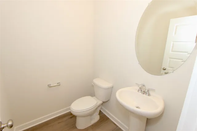a bathroom with a sink a toilet and mirror