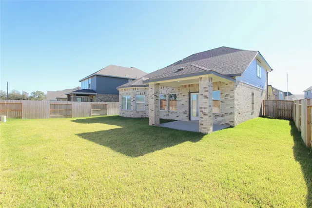 a view of a house with swimming pool and a yard