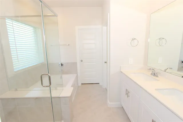 a bathroom with a granite countertop sink a shower and a mirror