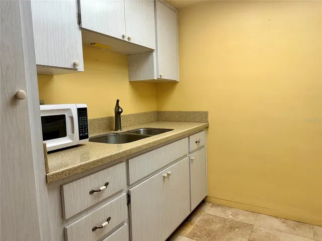 a kitchen with cabinets appliances and a sink