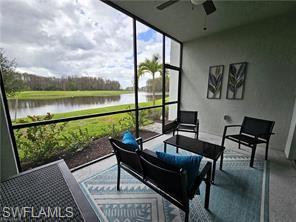 6039 Ellerston Way Avenue, Unit 2017 Immokalee, FL 34142 - Photo 14 of 34 a living room with a floor to ceiling window next to a yard