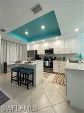 6039 Ellerston Way Avenue, Unit 2017 Immokalee, FL 34142 - Photo 2 of 34 a kitchen with stainless steel appliances kitchen island granite countertop a stove a sink and a microwave