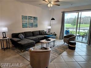 6039 Ellerston Way Avenue, Unit 2017 Immokalee, FL 34142 - Photo 5 of 34 a living room with furniture a flat screen tv and a large window