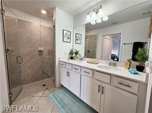 6039 Ellerston Way Avenue, Unit 2017 Immokalee, FL 34142 - Photo 10 of 34 a bathroom with a double vanity sink mirror and shower
