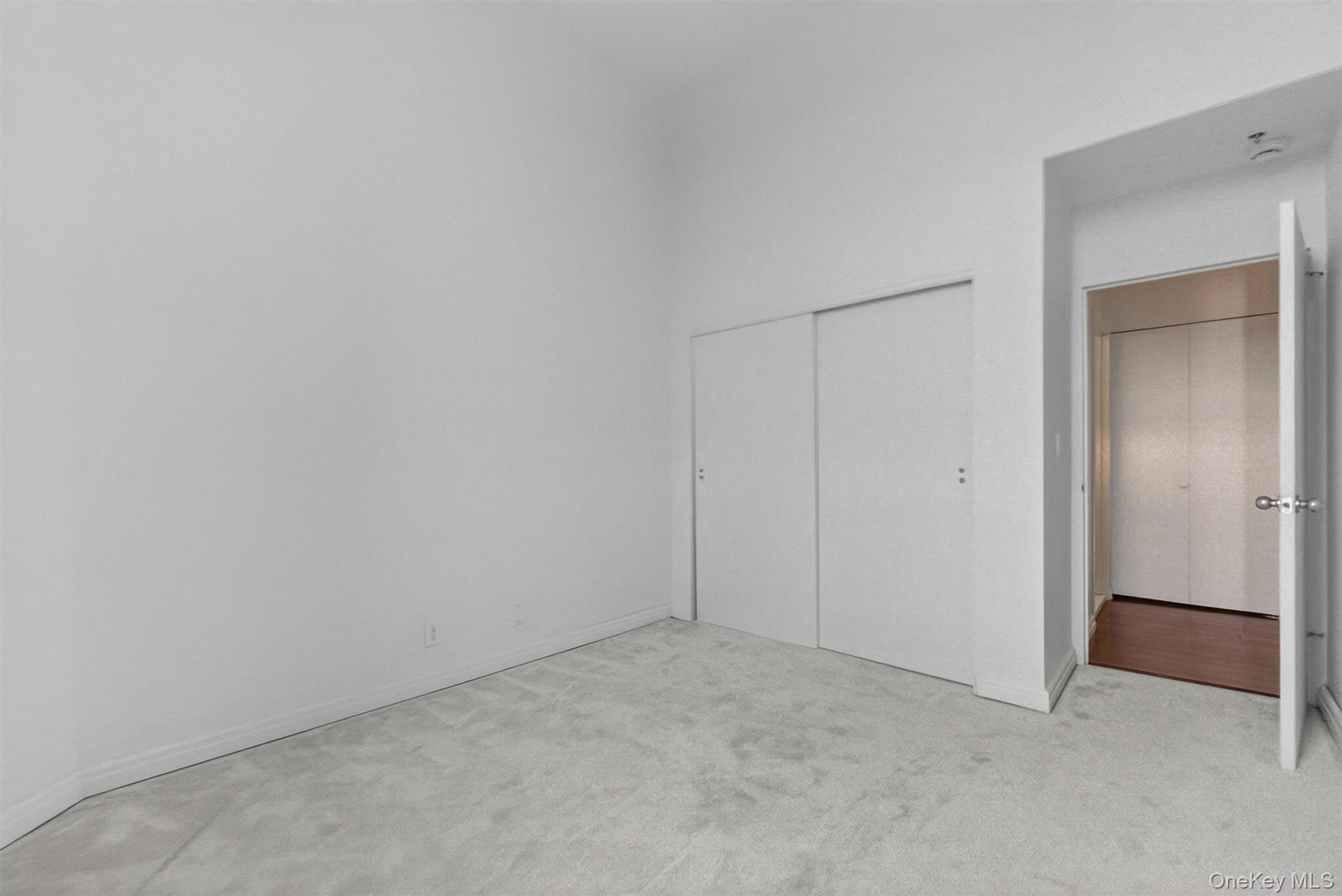 5211 Villa At The Peekskill, NY 10566 - Photo 17 of 19 Another perspective of the bedroom featuring the closet area and showcasing the room’s soaring ceilings, new windows, and beautiful wall-to-wall carpeting.