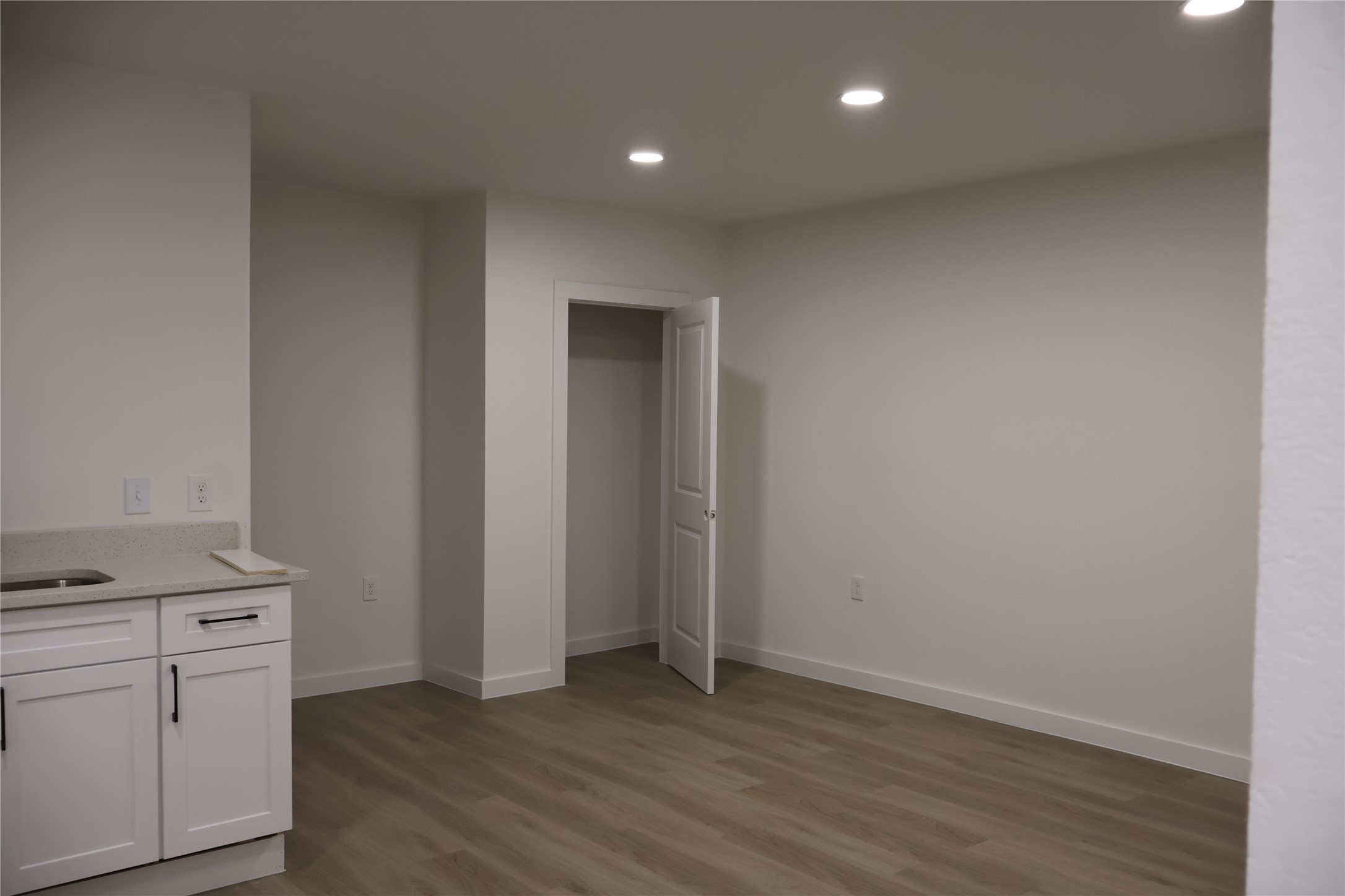 5602 Circlegate Drive, Unit B Spring, TX 77373 - Photo 5 of 8 an empty room with wooden floor and closet