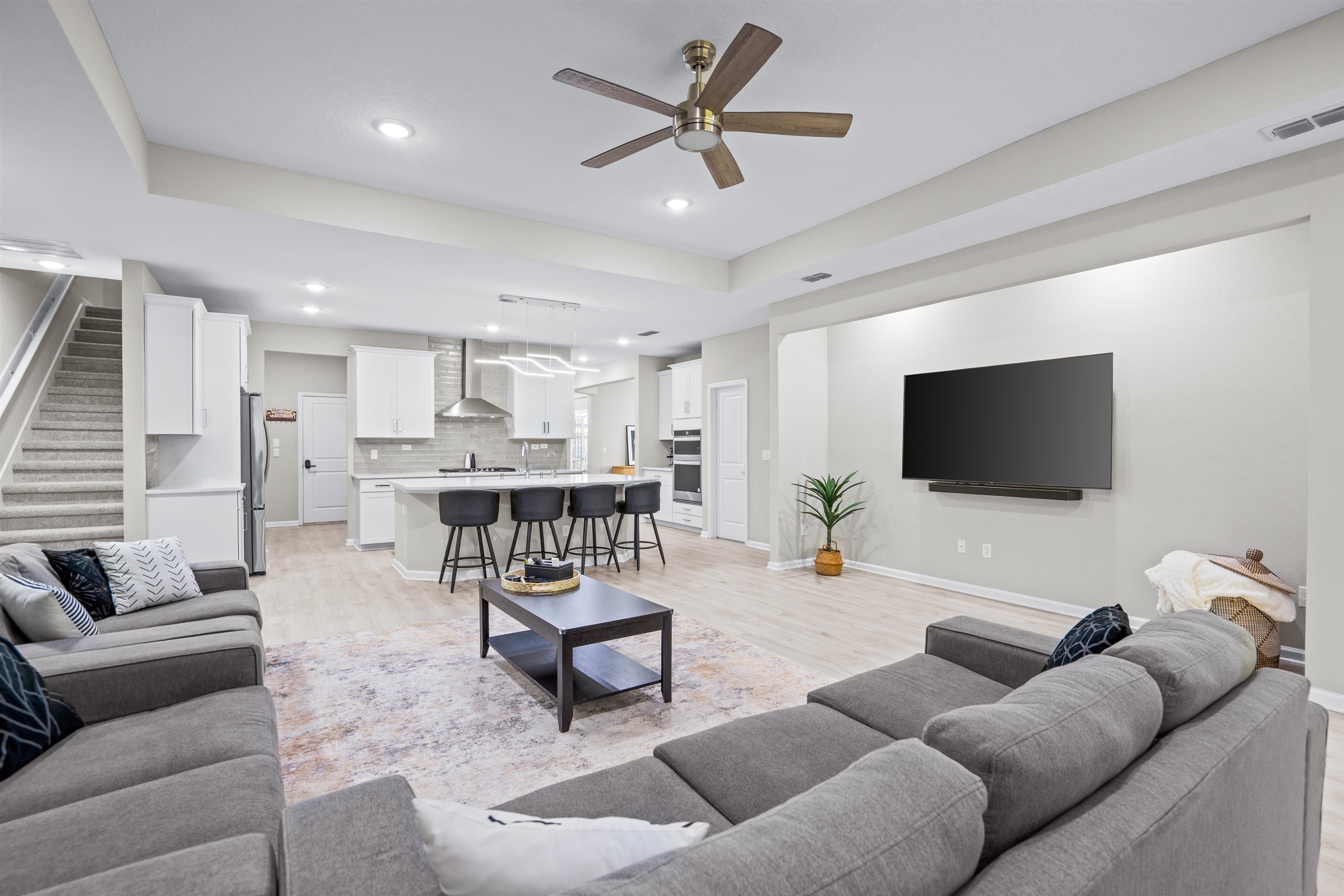 207 Archstone Way St. Augustine, FL 32092 - Photo 15 of 49 a living room with furniture and a flat screen tv with wooden floor