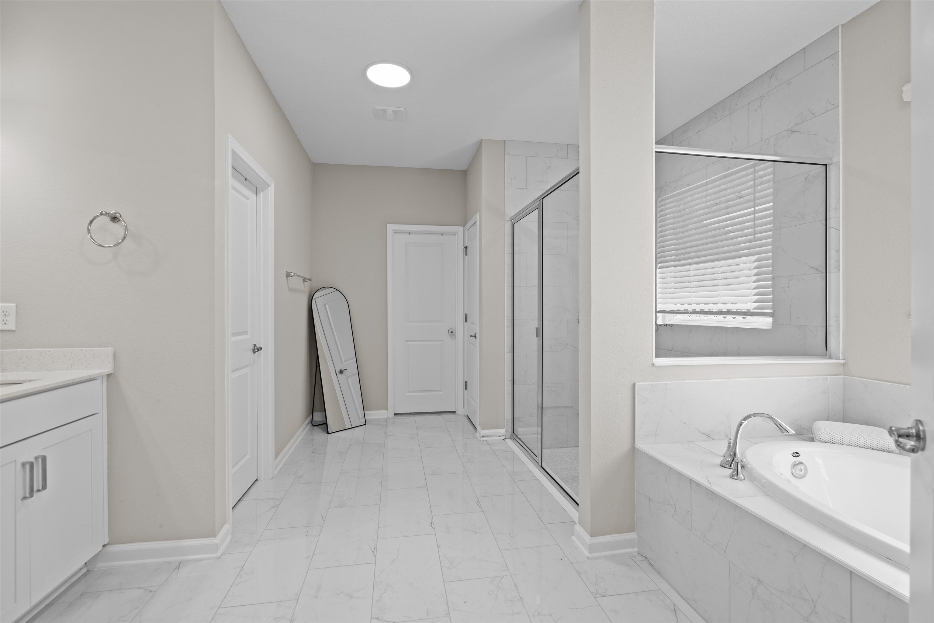 207 Archstone Way St. Augustine, FL 32092 - Photo 18 of 49 a bathroom with a tub sink and mirror