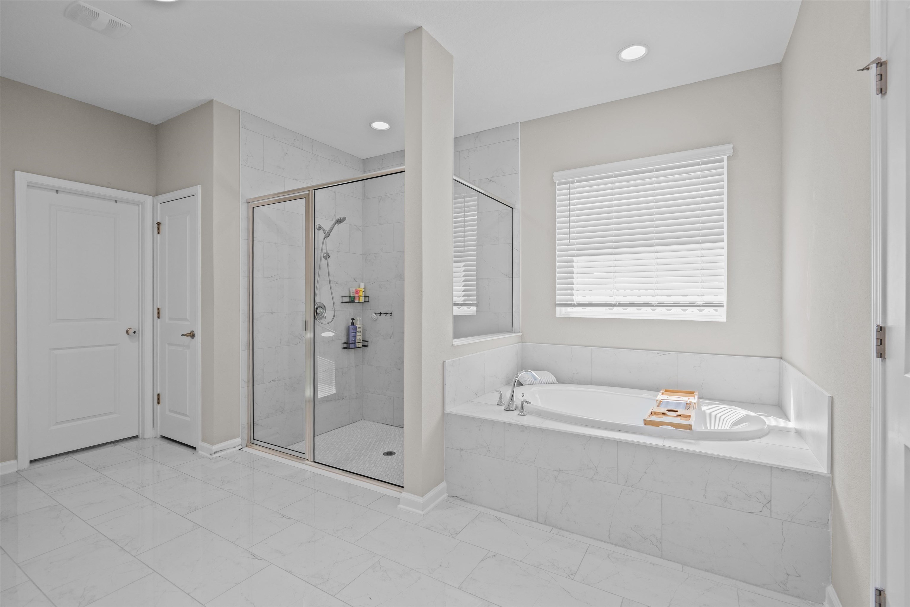 207 Archstone Way St. Augustine, FL 32092 - Photo 20 of 49 a spacious bathroom with a tub shower a mirror and a sink