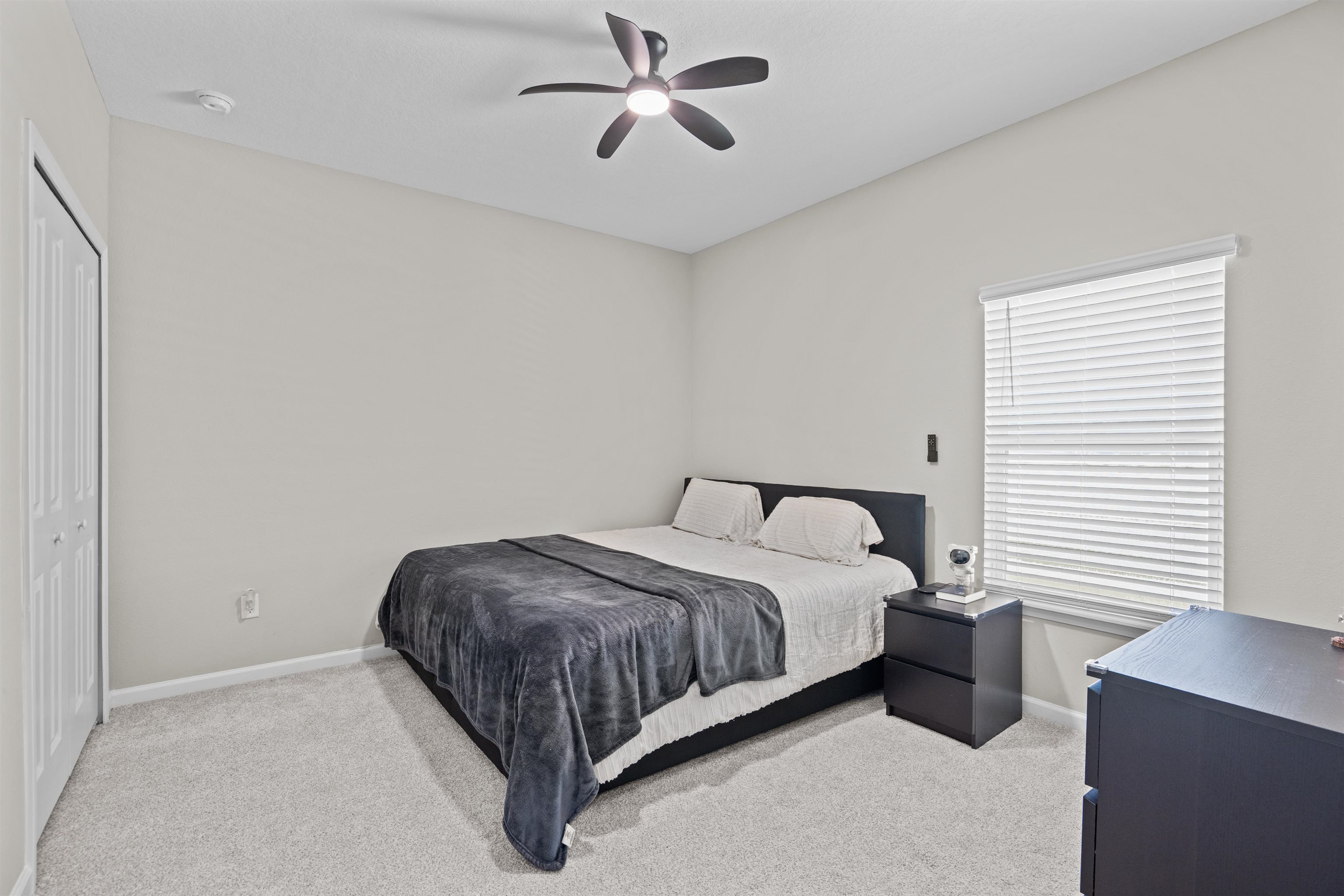 207 Archstone Way St. Augustine, FL 32092 - Photo 21 of 49 a bedroom with a bed and a chandelier fan