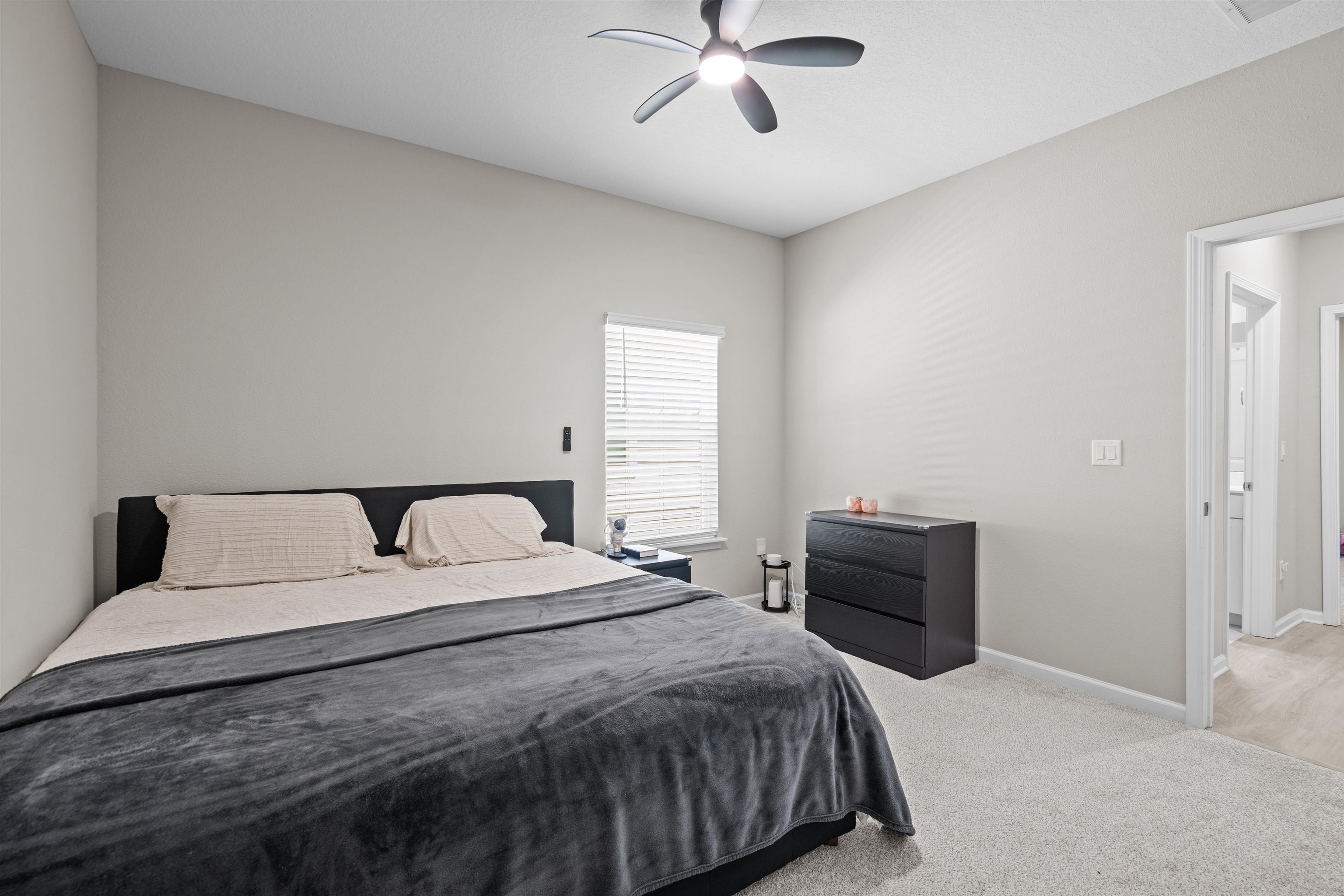 207 Archstone Way St. Augustine, FL 32092 - Photo 22 of 49 a bedroom with a large bed and a chandelier