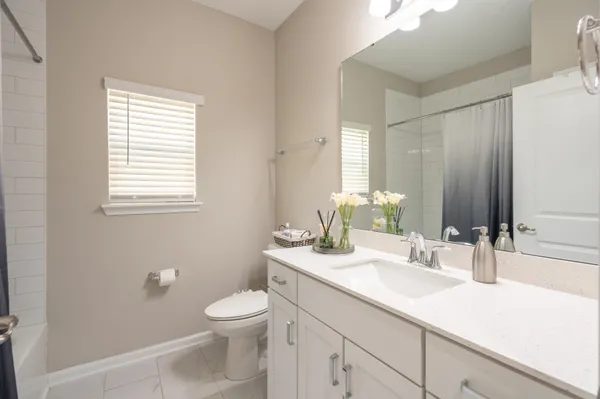 a spacious bathroom with a tub shower a mirror and a sink