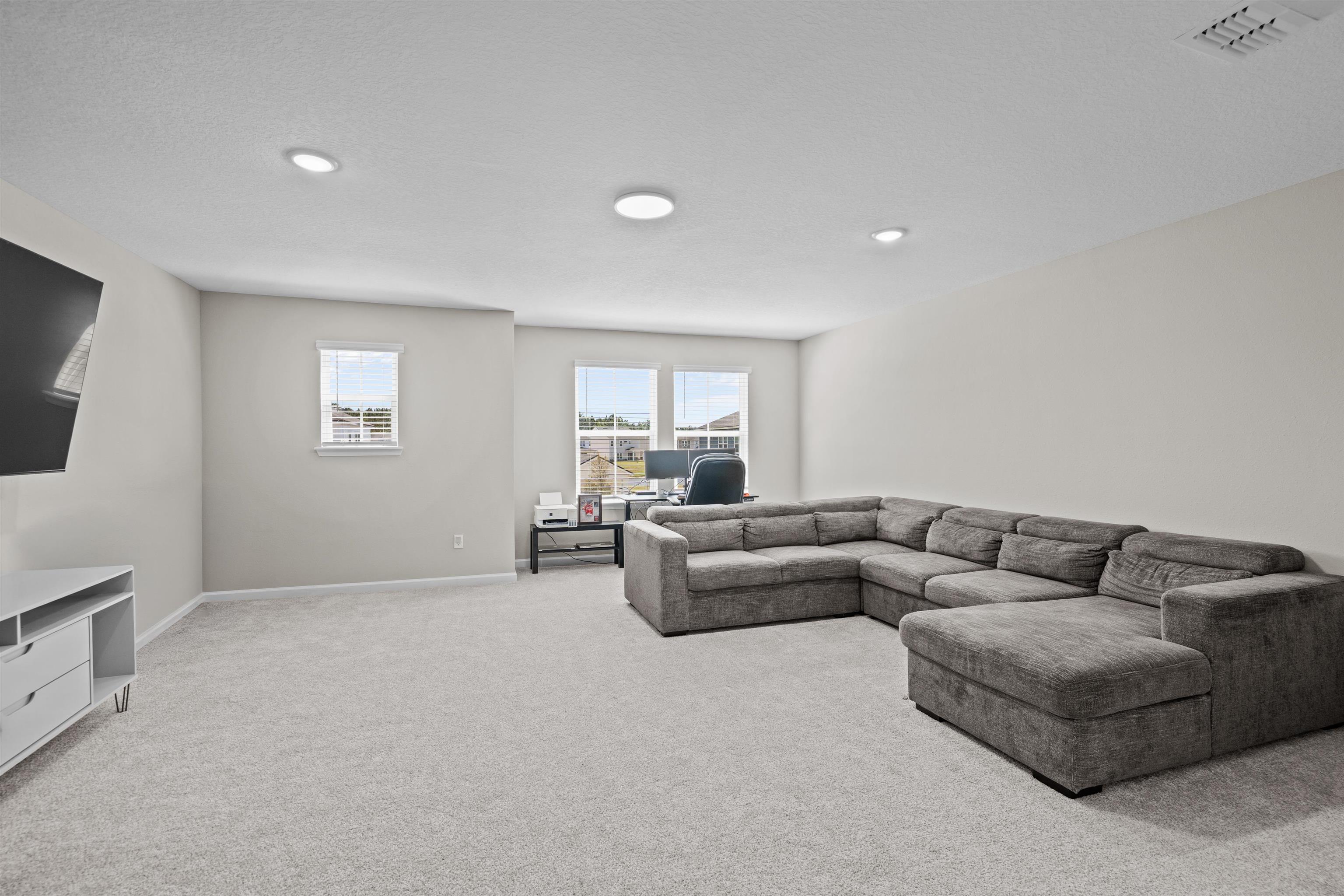 207 Archstone Way St. Augustine, FL 32092 - Photo 29 of 49 a living room with furniture and a flat screen tv