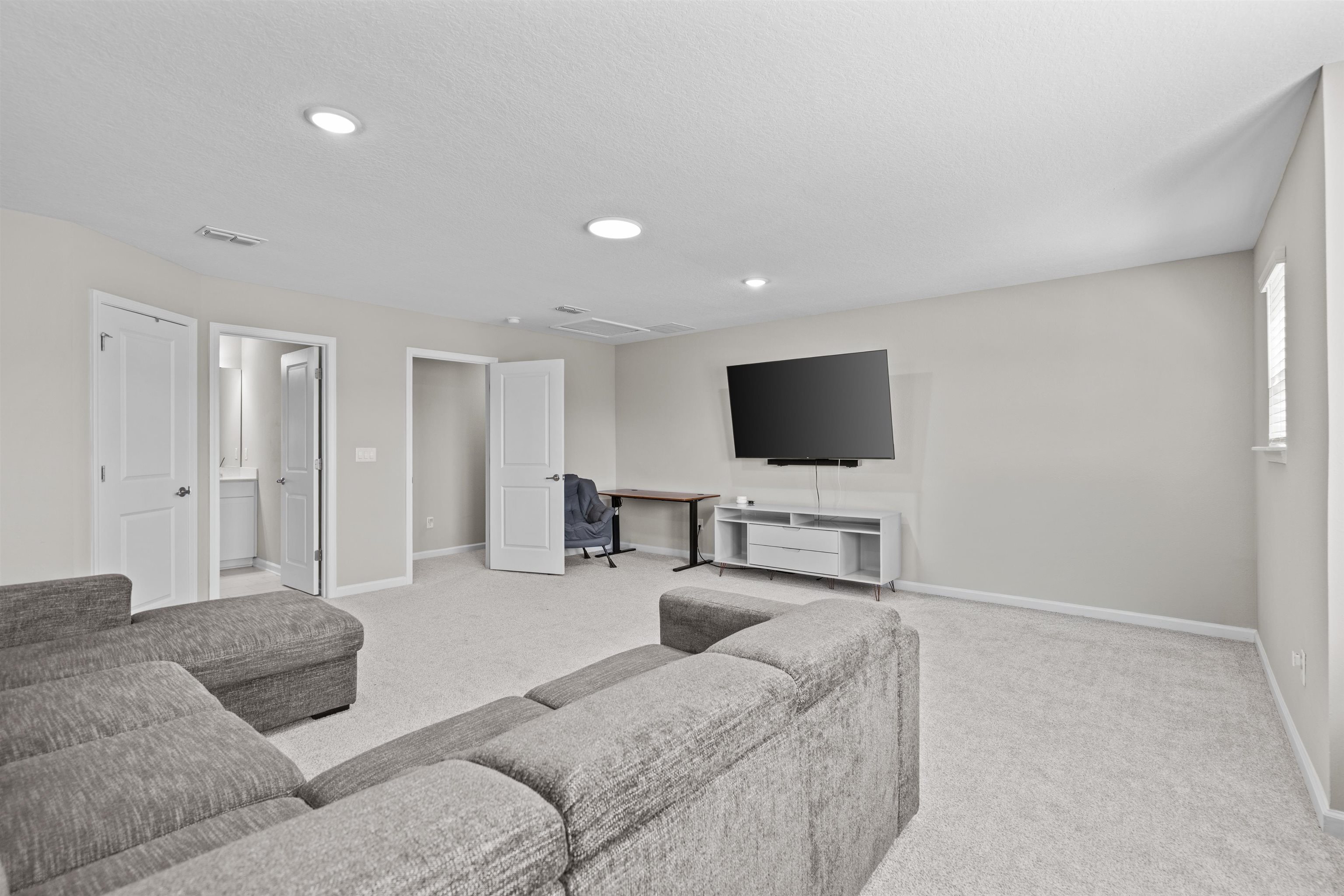 207 Archstone Way St. Augustine, FL 32092 - Photo 30 of 49 a living room with furniture and a flat screen tv