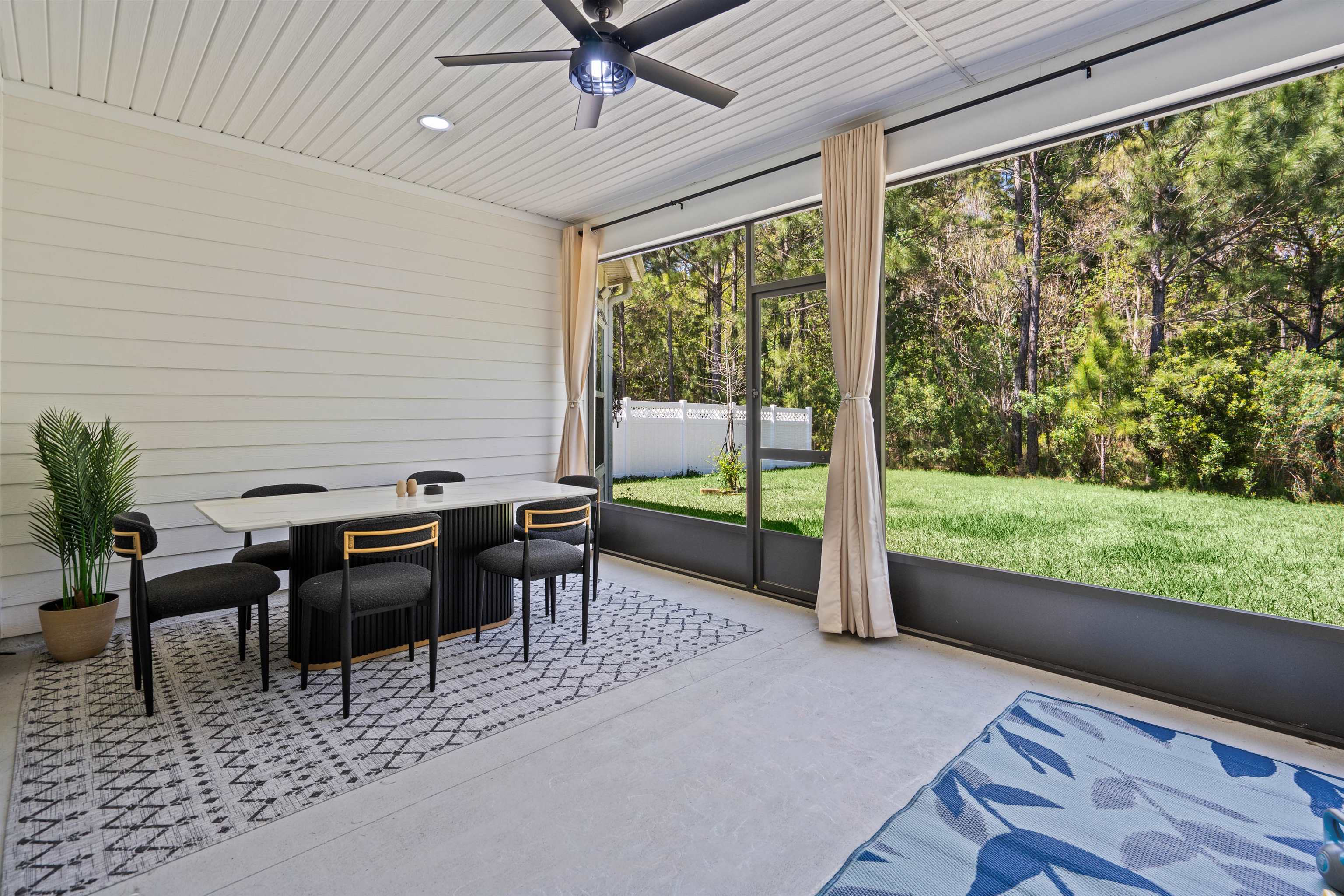 207 Archstone Way St. Augustine, FL 32092 - Photo 32 of 49 a view of a patio with table and chairs floor to ceiling window with wooden floor