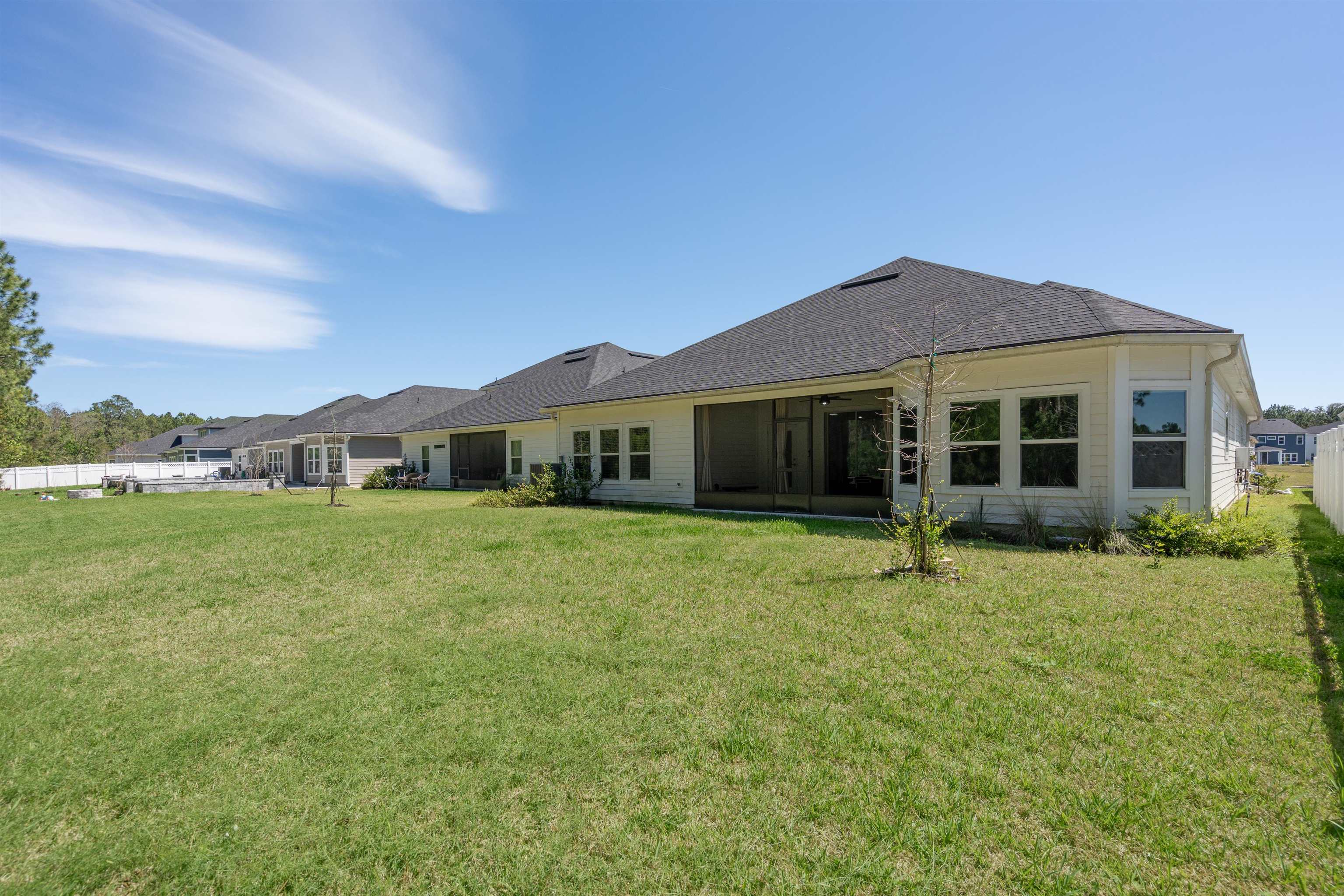 207 Archstone Way St. Augustine, FL 32092 - Photo 37 of 49 a front view of a house with a garden and yard