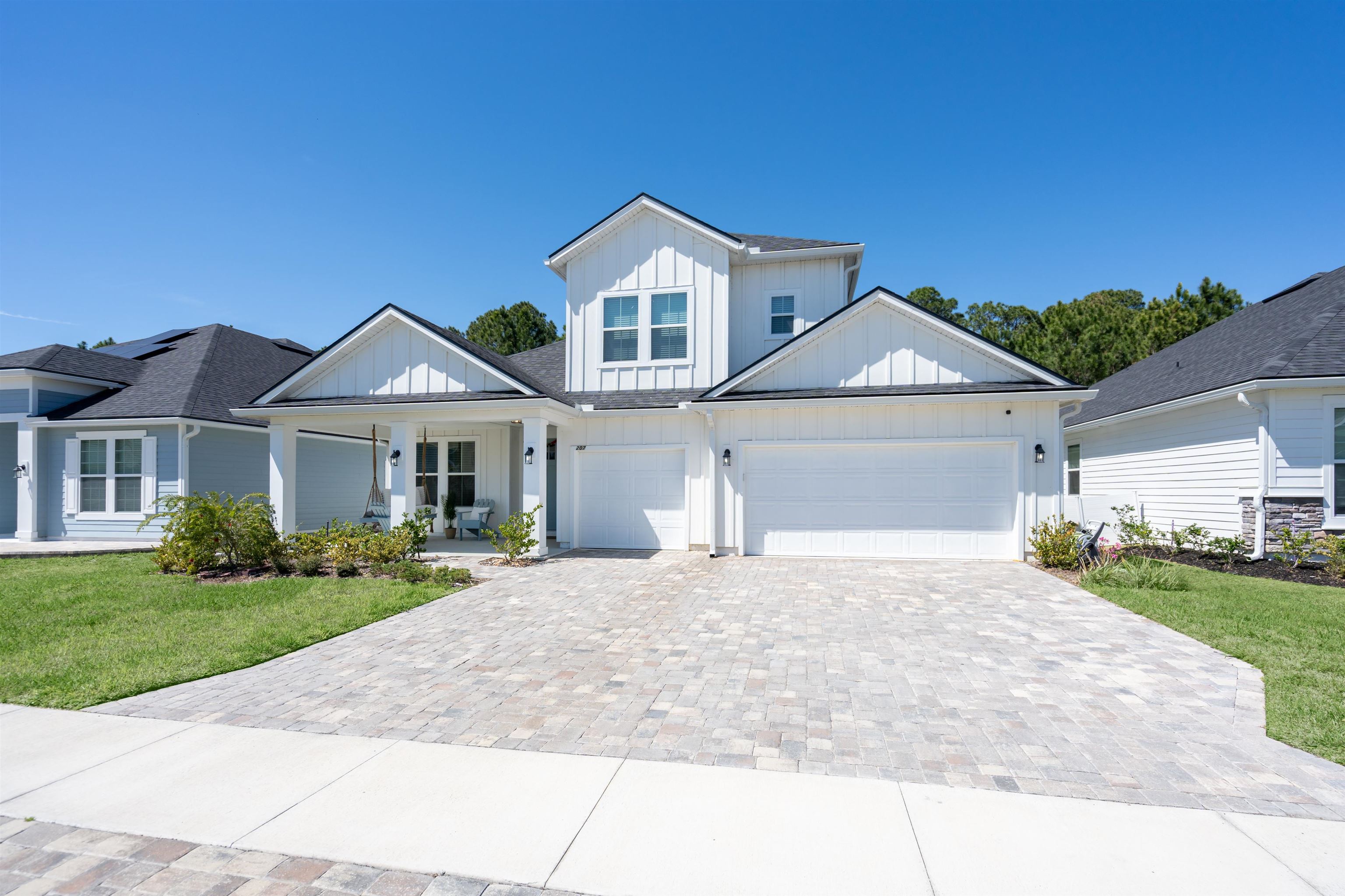 207 Archstone Way St. Augustine, FL 32092 - Photo 46 of 49 a front view of a house with a yard and garage