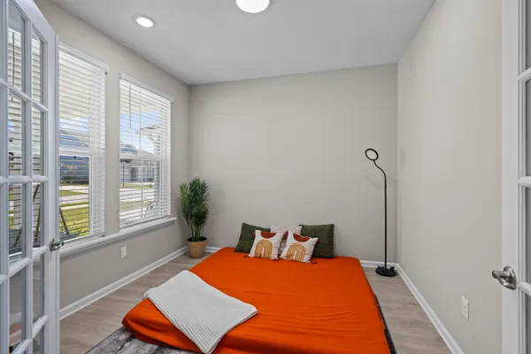a bed room with a bed and a chair
