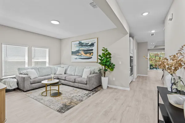 a living room with furniture and a large window