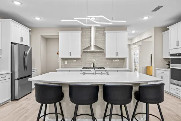 a kitchen with a sink cabinets stainless steel appliances and a window