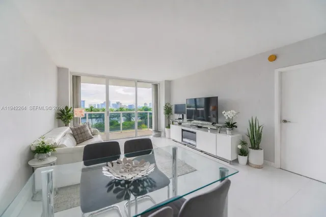 a living room with furniture a large window and a flat screen tv
