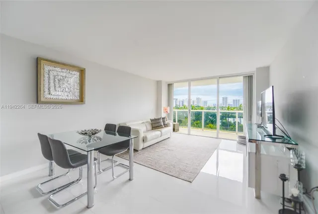 a living room with furniture and a floor to ceiling window