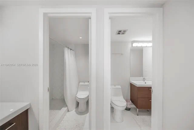 a bathroom with a toilet a sink and shower