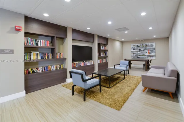 a sitting area with furniture and wooden floor