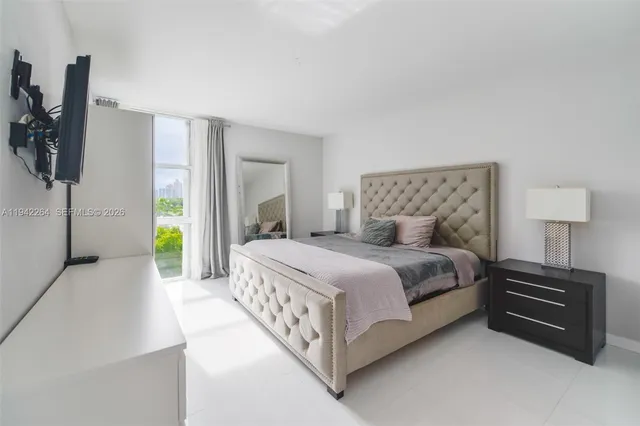 a bedroom with a bed and a lamp on table