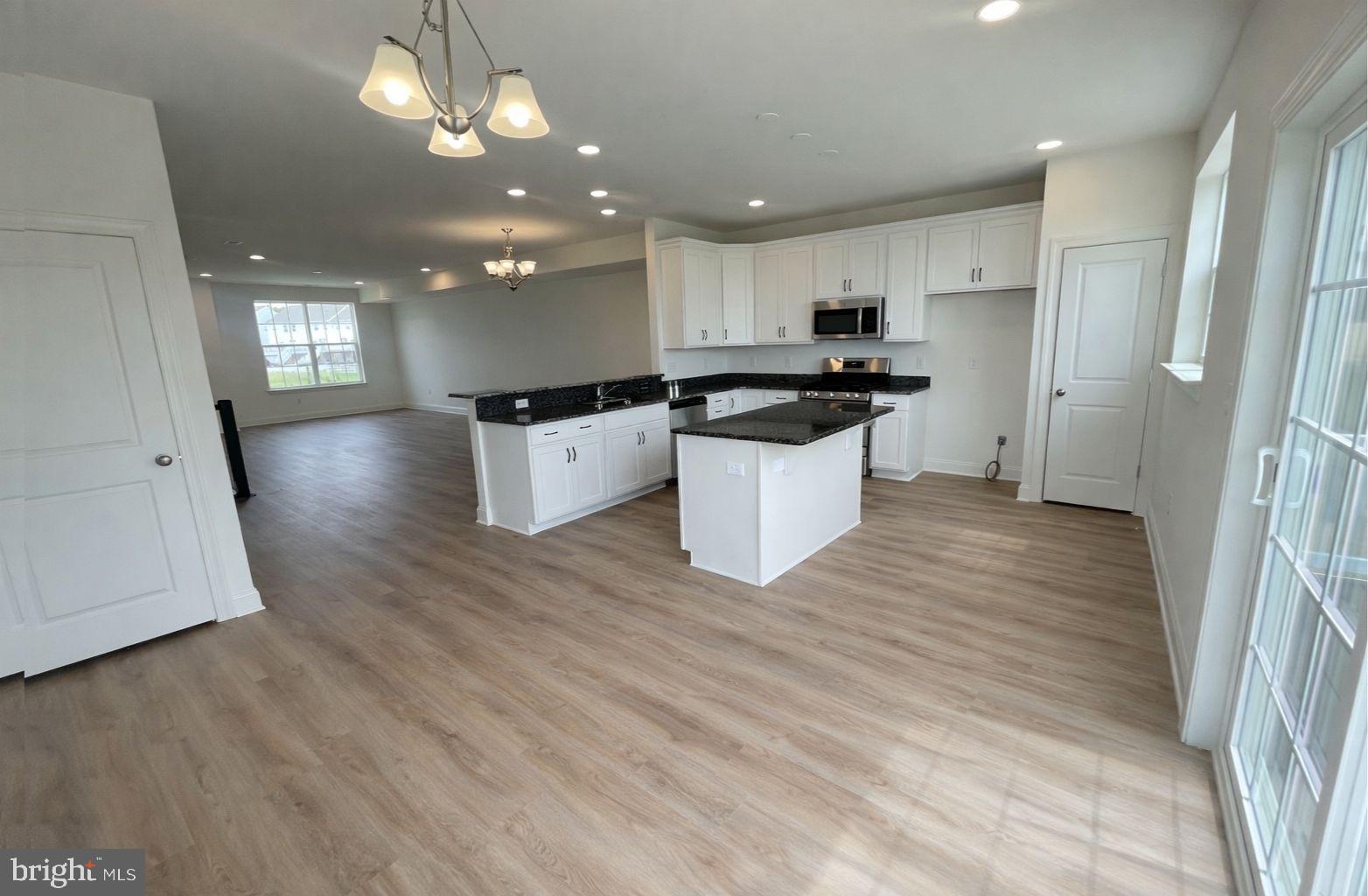 442 Rederick Lane Middletown, DE 19709 - Photo 5 of 16 a large kitchen with a large counter top a sink a refrigerator and a stove