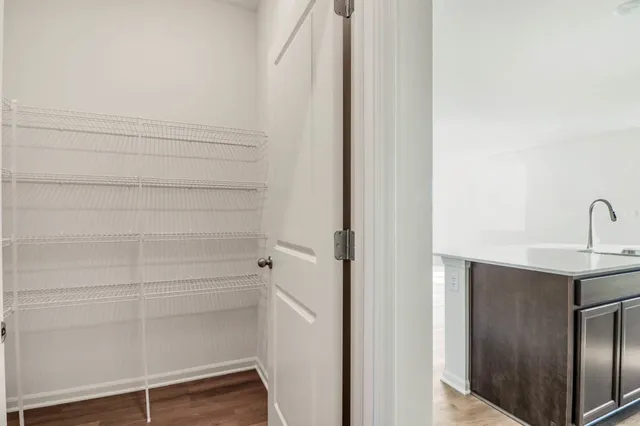 a view of a living room with hardwood floor and a ceiling fan