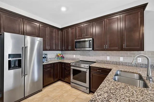 a kitchen with granite countertop stainless steel appliances and sink