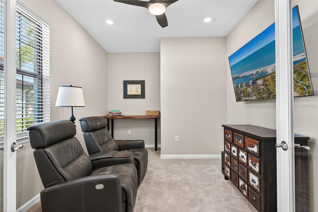 5821 Mayflower Way Ave Maria, FL 34142 - Photo 14 of 36 a living room with furniture and a flat screen tv