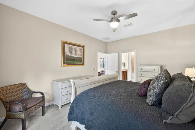 a living room with a bed furniture chandelier and a window