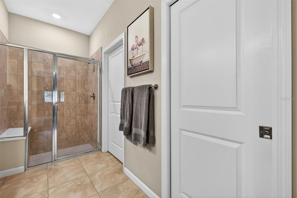 5821 Mayflower Way Ave Maria, FL 34142 - Photo 20 of 36 a bathroom with a shower and a mirror