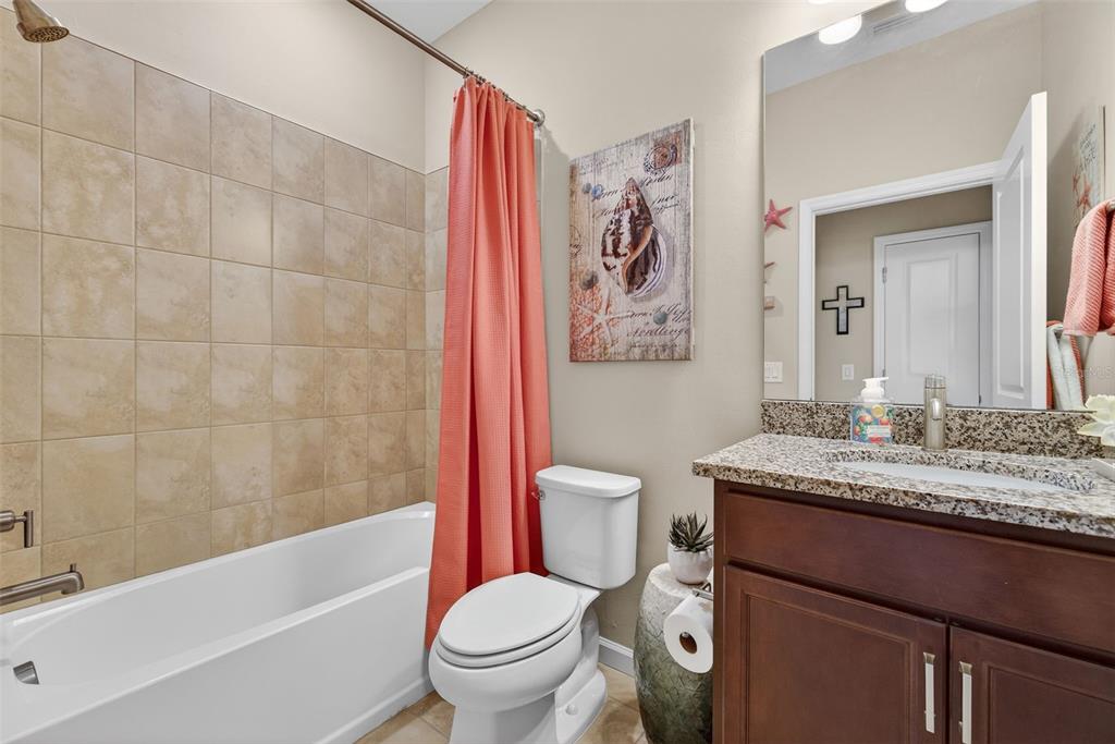 5821 Mayflower Way Ave Maria, FL 34142 - Photo 22 of 36 a bathroom with a granite countertop toilet a sink and bathtub