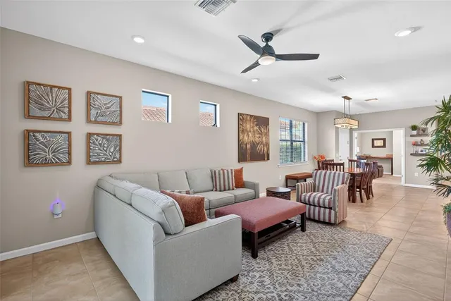 a living room with furniture wooden floor and window