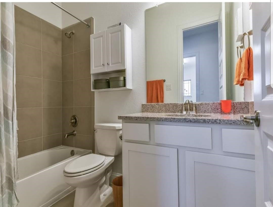 13326 Lake Chesdin Road Houston, TX 77044 - Photo 13 of 23 a bathroom with a granite countertop sink a toilet and shower