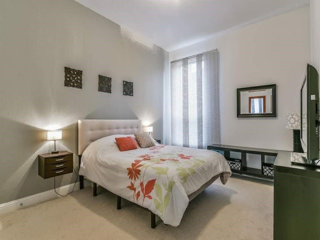 13326 Lake Chesdin Road Houston, TX 77044 - Photo 20 of 23 a bedroom with a bed and wooden floor