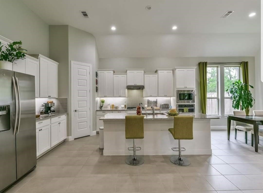 13326 Lake Chesdin Road Houston, TX 77044 - Photo 4 of 23 a kitchen with cabinets and chairs