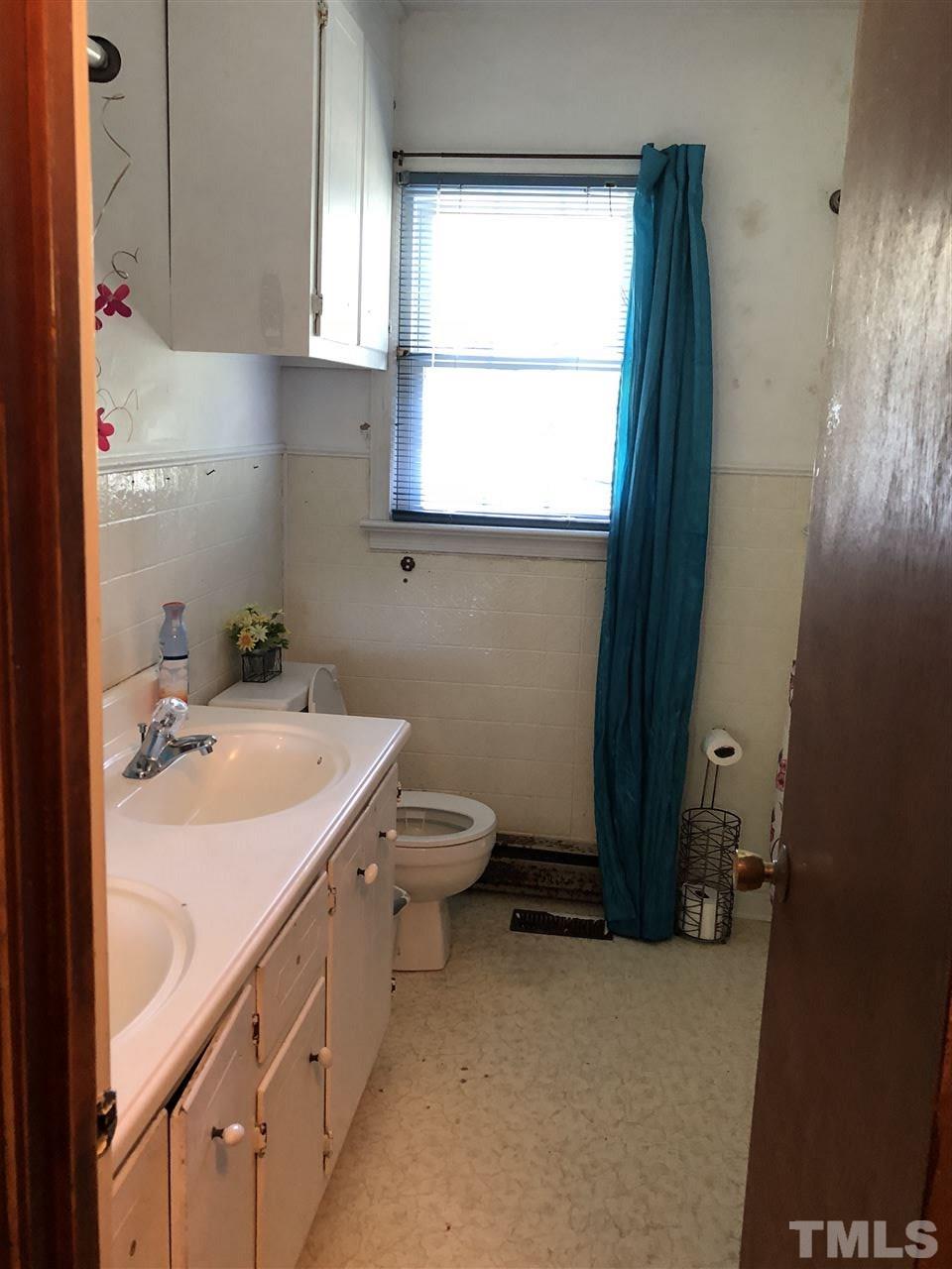 956 Fire Lane Road Bunnlevel, NC 28323 - Photo 14 of 16 a bathroom with a sink toilet and window