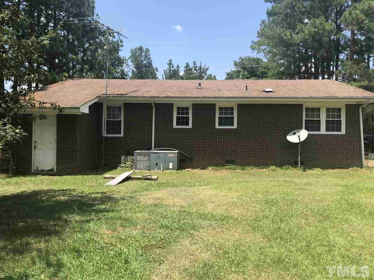 956 Fire Lane Road Bunnlevel, NC 28323 - Photo 3 of 16 a backyard of a house with yard and garage