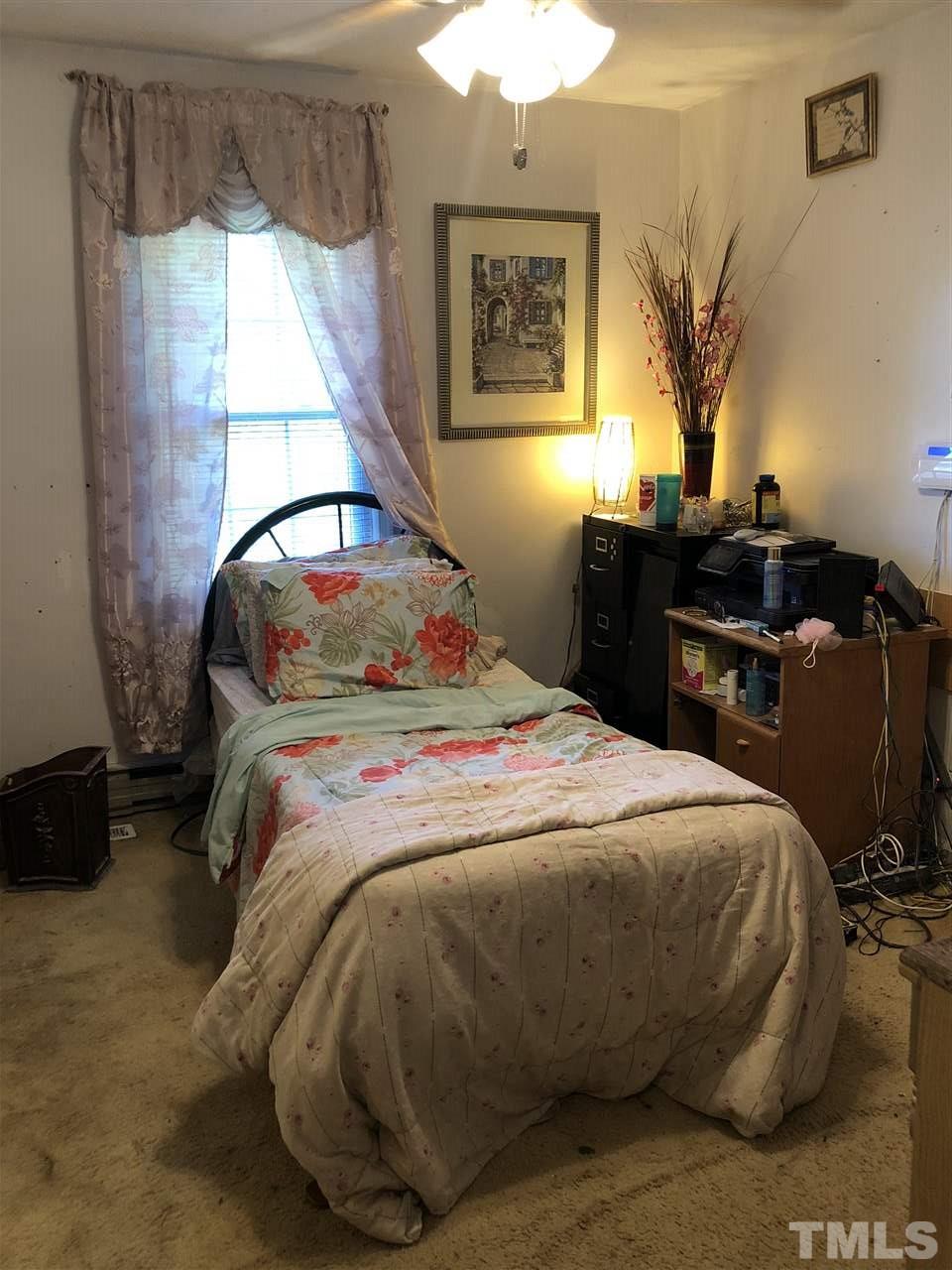956 Fire Lane Road Bunnlevel, NC 28323 - Photo 10 of 16 a bedroom with a bed and a window