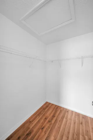 a view of a room with wooden floor