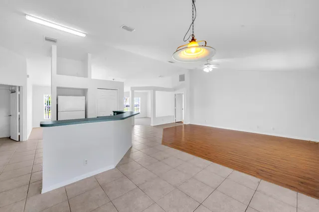 a view of kitchen and hall with wooden floor