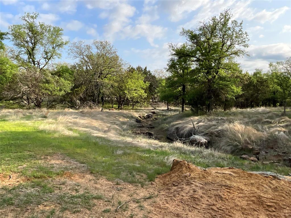 2991 Village Bend Road Mineral Wells, TX 76067 - Photo 2 of 23 a view of a dirt road with a building in the background